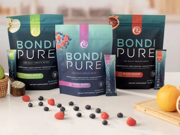 Three Bondi Pure pouches, Green Apple, Mixed Berry and Blood Orange, on a kitchen counter.